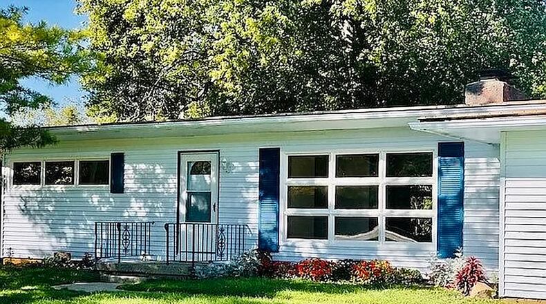 Offering an open concept floor plan, the 3-bedroom home boasts large windows and wooded views. The home has about 1,430 sq. ft. of living space and features numerous updates. CONTRIBUTED PHOTO