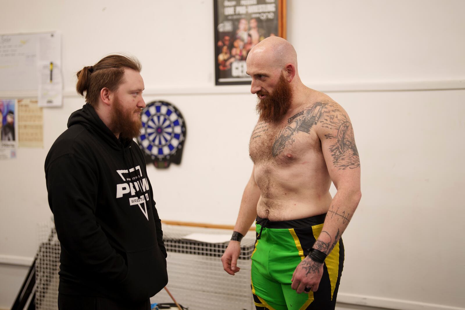 Wrestlers Will Valour, left speaks with fellow competitor Lawson, both stage names, backstage at St Peter's Church in Shipley before one of the Kingdom Wrestling's monthly wrestling shows, Saturday, March 29, 2025. (AP Photo/Jon Super)