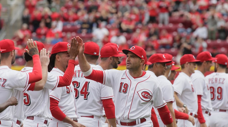 Joey Votto, of the Reds, is introduced before a game between the Reds and Guardians on Opening Day on Tuesday, April 12, 2022, at Great American Ball Park in Cincinnati. David Jablonski/Staff