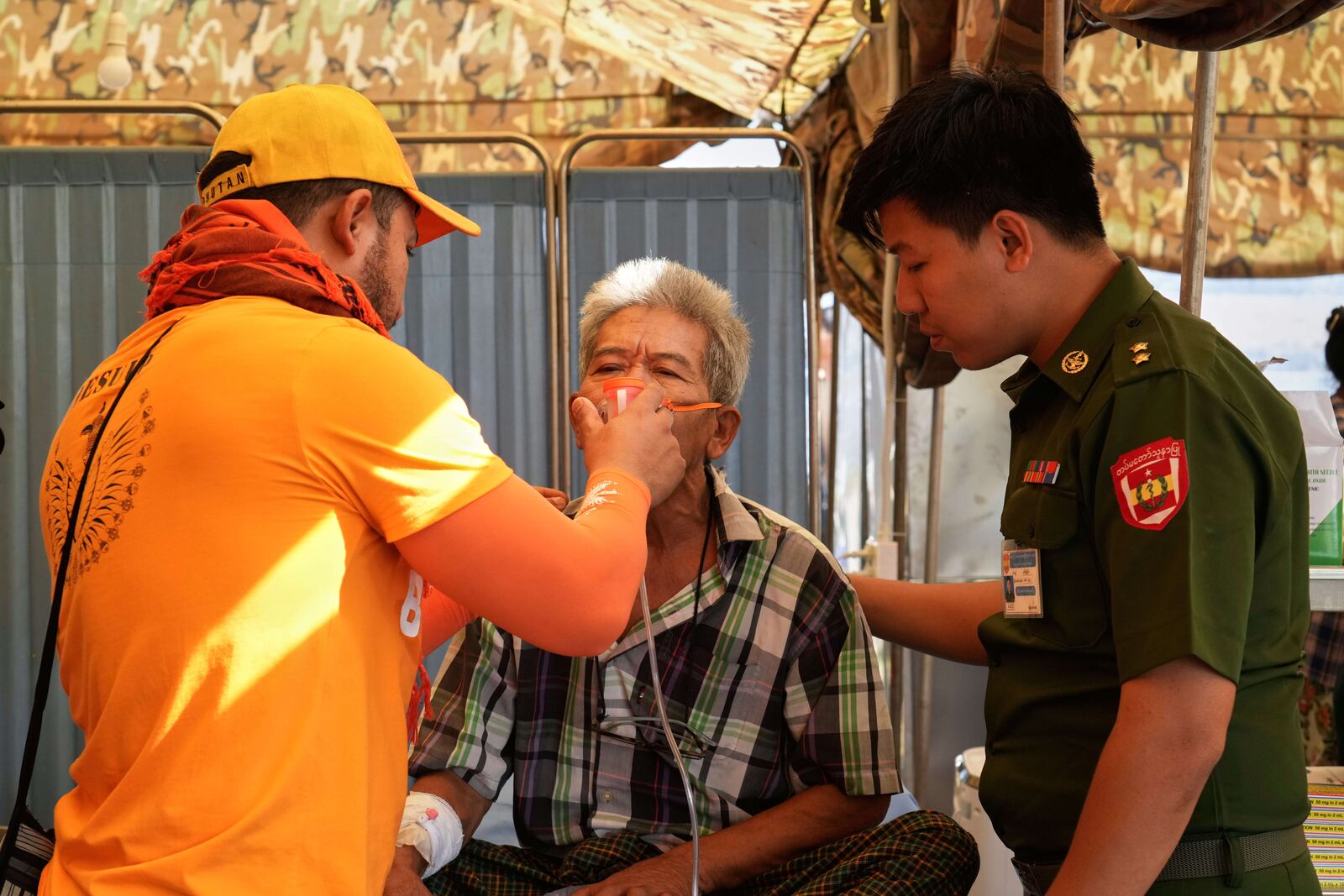 Medical volunteers attend to patients at a make-shift tent opened for medical care after last week's earthquake in Naypyitaw, Myanmar, Friday, April 4, 2025. (AP Photo)