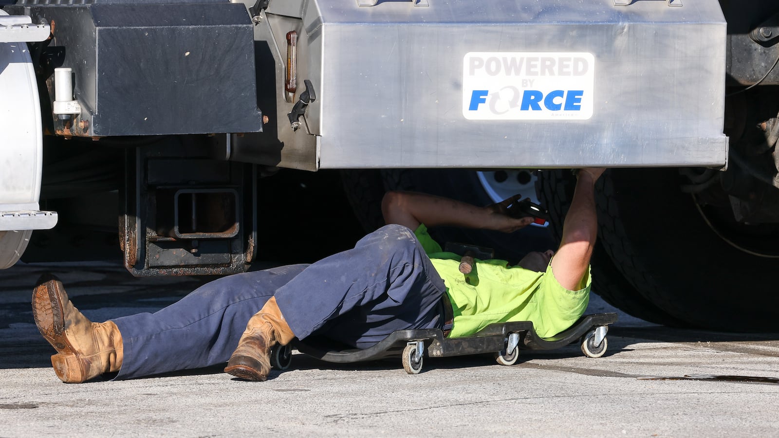 An Ohio Department of Transportation worker inspects a truck used as a snow plow on Wednesday, Oct. 16  at the department's Montgomery County garage in Clayton. BRYANT BILLING / STAFF