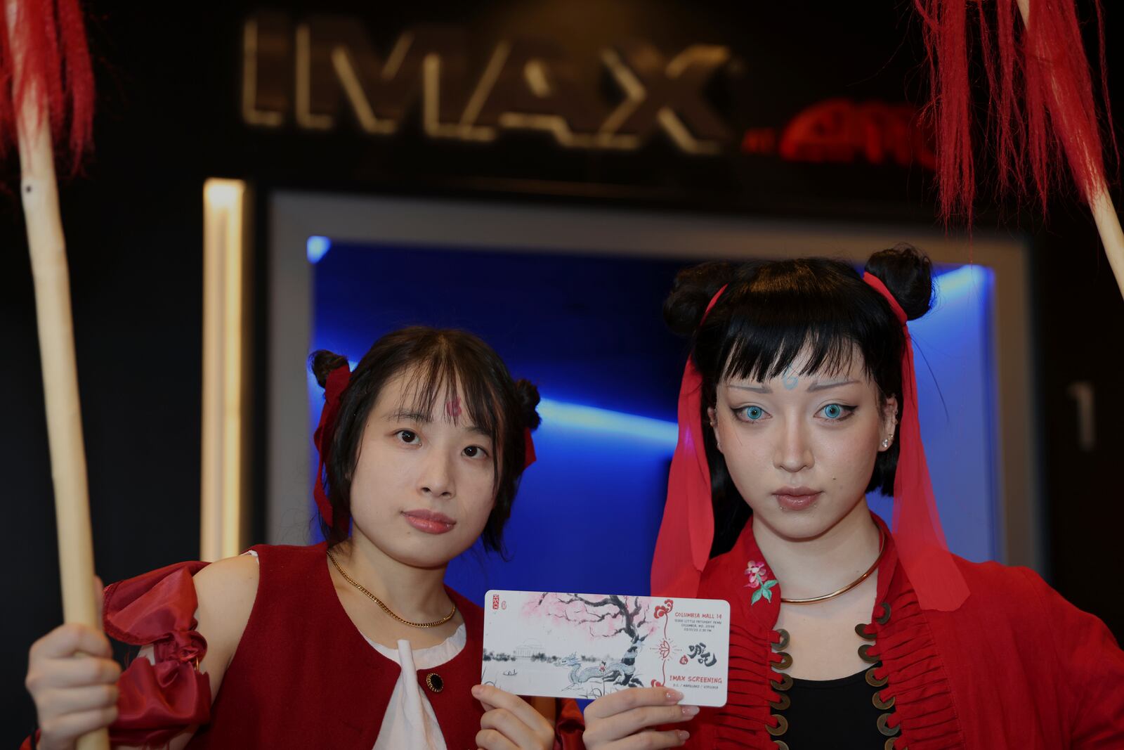 This photo provided by Jialin Sun shows Hoff Xu and Raye Xia, both cosplaying characters for the movie Ne Zha 2, posing for a picture at a screening in Columbia Md., on March 1. (Jialin Sun via AP)