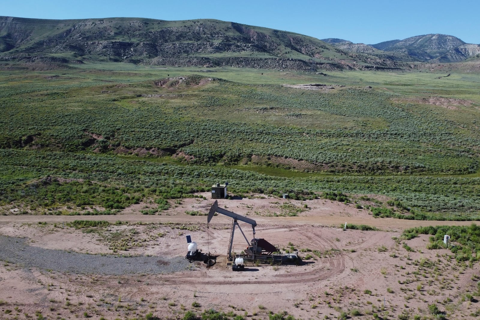 FILE - A pumpjack dips its head to extract oil in a basin north of Helper, Utah, July 13, 2023. (AP Photo/Rick Bowmer, File)