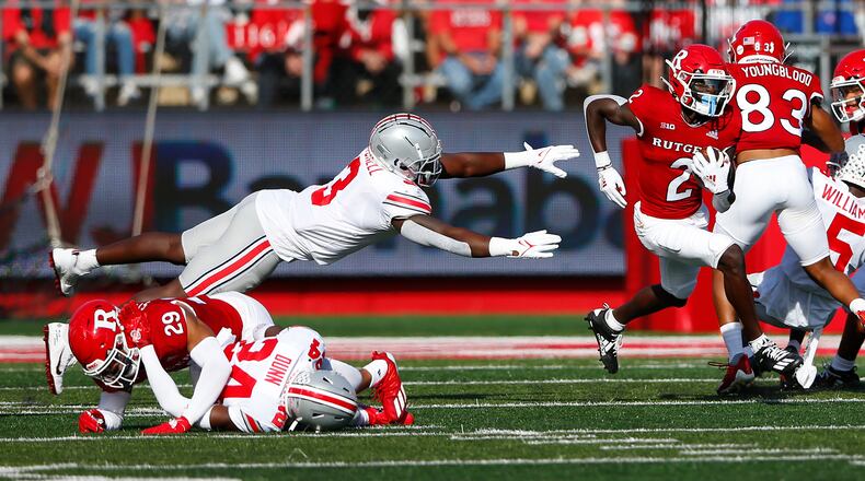 Rutgers wide receiver Aron Cruickshank (2) runs away from Ohio State linebacker Teradja Mitchell (3)  during an NCAA college football game, Saturday, Oct. 2, 2021, in Piscataway, N.J. (AP Photo/Noah K. Murray)