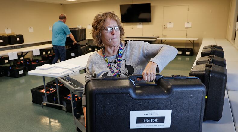 Susan King-Evans sets out ePoll Books for each precinct at the Clark County Board of Elections on Monday, Nov. 7, 2022, as they get ready for Election Day. Polling places will be open today from 6:30 a.m. until 7:30 p.m. BILL LACKEY/STAFF