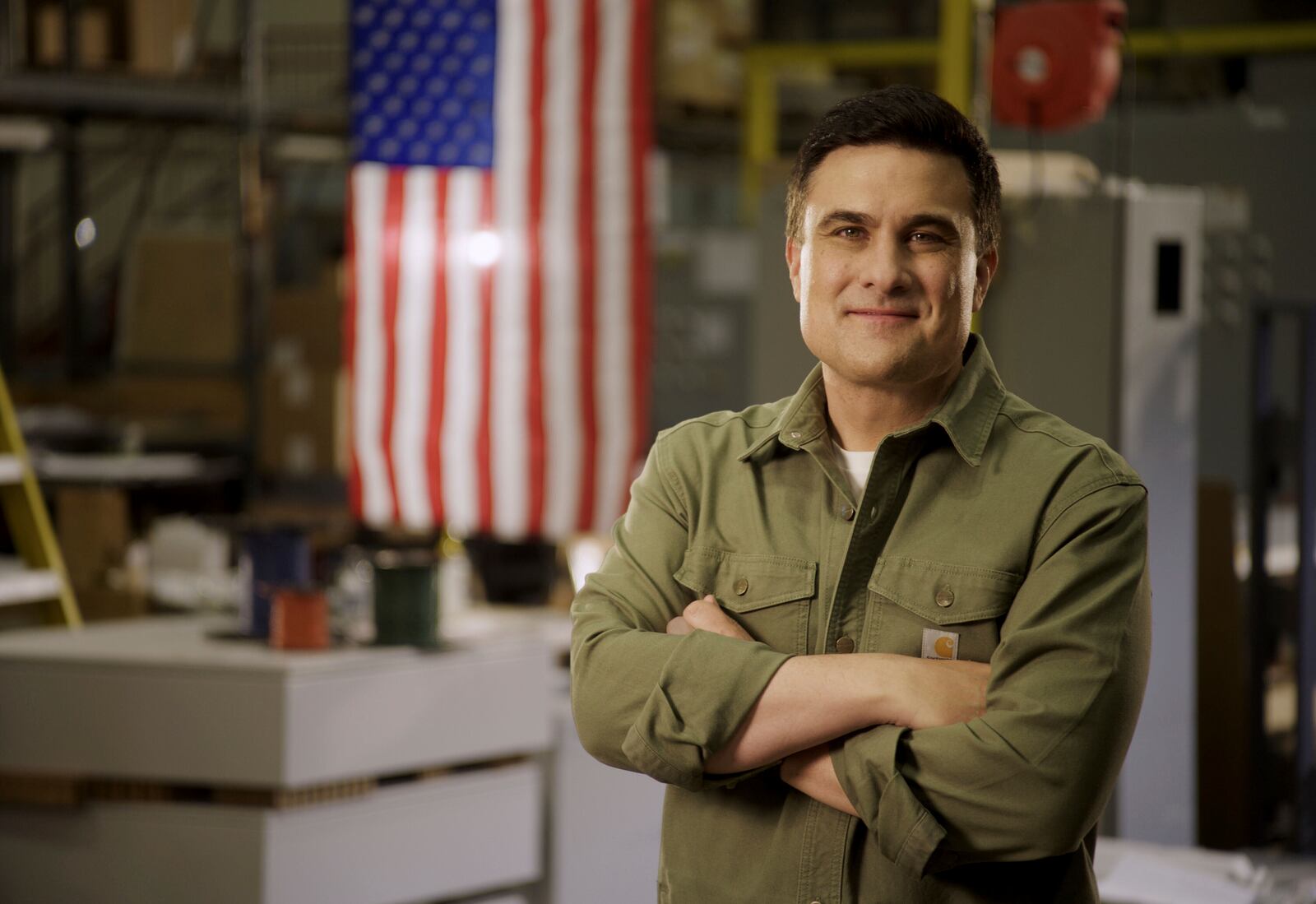 This undated photo provided by the Morris for Senate Campaign shows Republican businessman Nate Morris posing while visiting a factory in Louisville, Ky. (Max Cowan/Morris for Senate Campaign via AP)
