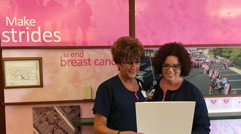 Tracy Adrian (right) Springfield Regional Cancer Center’s Breast Health Navigator, goes over plans for Breast Cancer Awareness Month with the center’s Teresa Hawke. CONTRIBUTED PHOTO BY BRETT TURNER