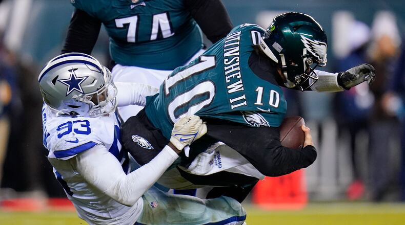 Dallas Cowboys defensive end Tarell Basham, left, sacks Philadelphia Eagles quarterback Gardner Minshew during the second half of an NFL football game, Saturday, Jan. 8, 2022, in Philadelphia. (AP Photo/Julio Cortez)