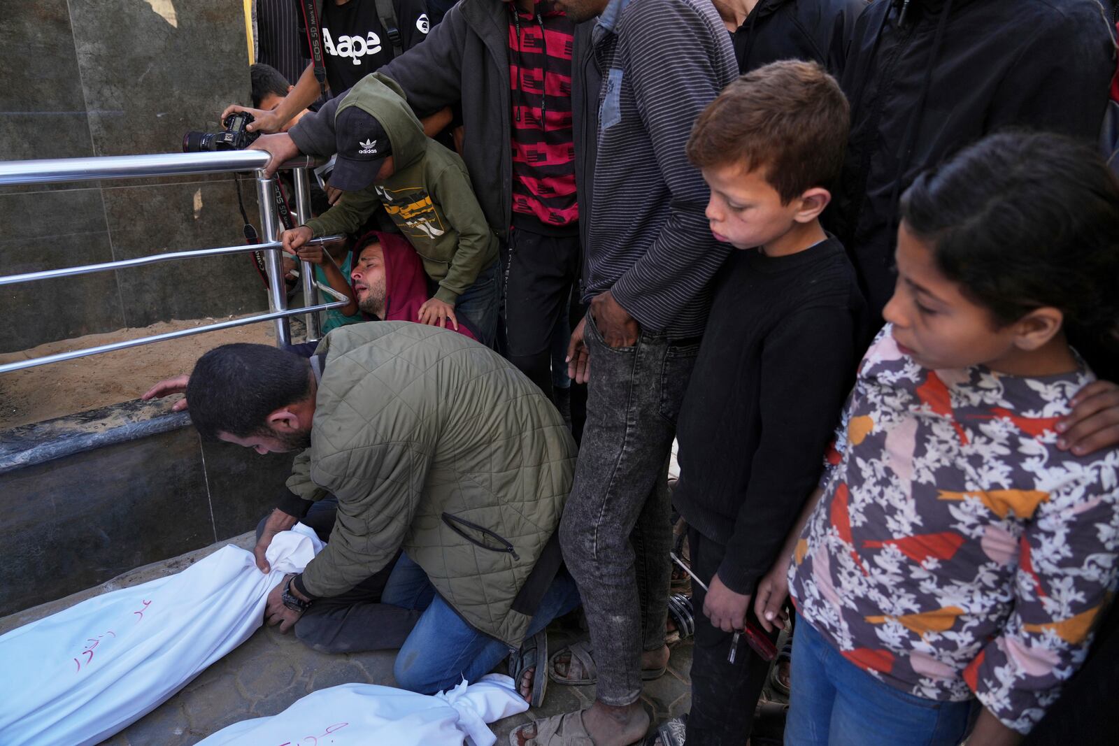 Palestinians mourn over the bodies of their relatives who were killed in an Israeli airstrike, as they brought to Shifa Hospital in Gaza City, on Saturday, April 26, 2025. (AP Photo/Jehad Alshrafi)