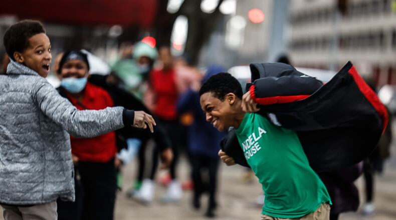DECA Middle School students brace against high wind at the intersection of Main Street and Second Street in downtown Dayton Thursday February 9, 2023. There is a high wind warning today where winds could guest up to 60 miles per hour. JIM NOELKER/STAFF