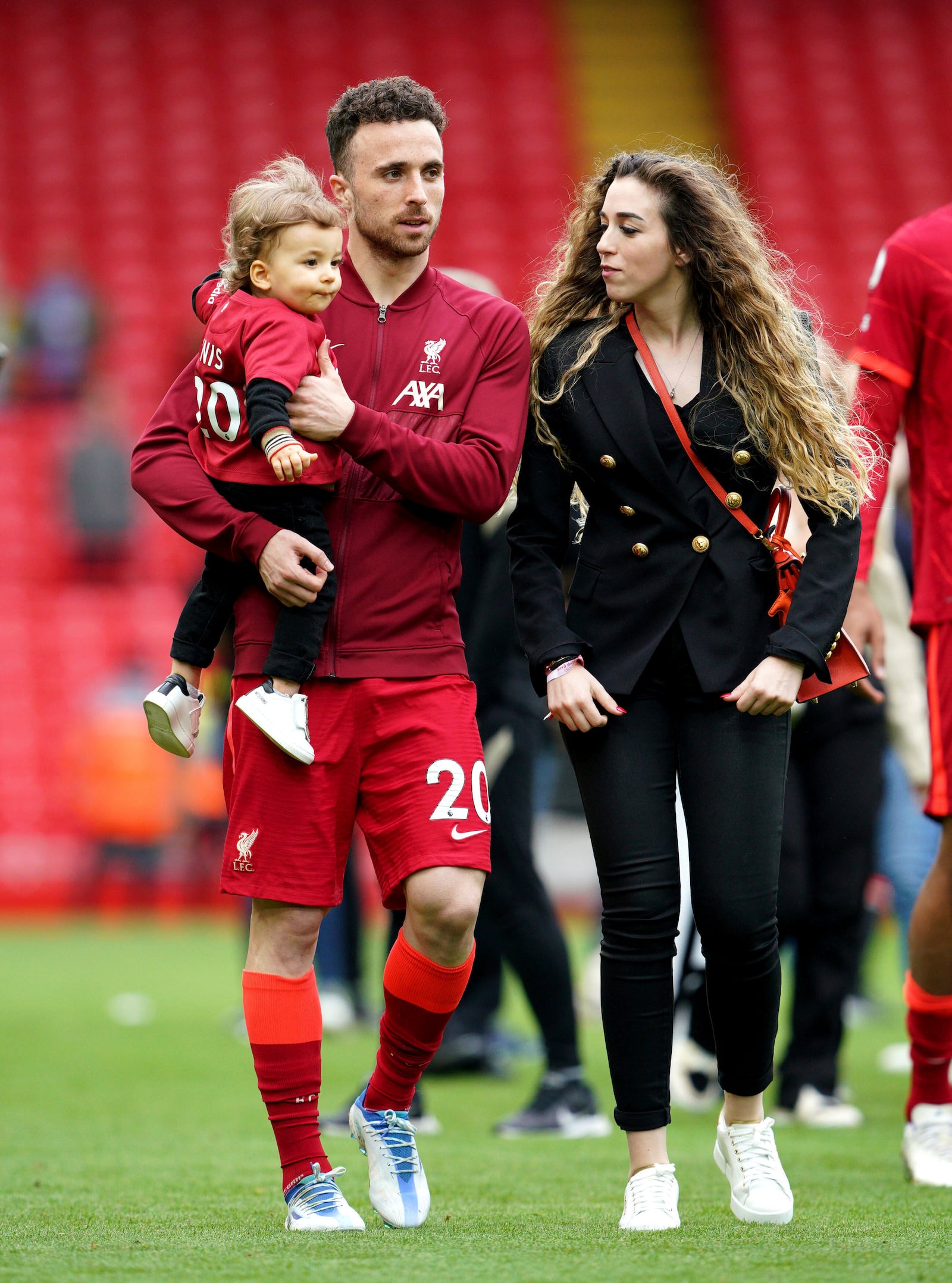 FILE - Liverpool's Diogo Jota walks the pitch with his family after the Premier League match at Anfield, Liverpool, Sunday May 22, 2022. (Peter Byrne/PA via AP, File)
