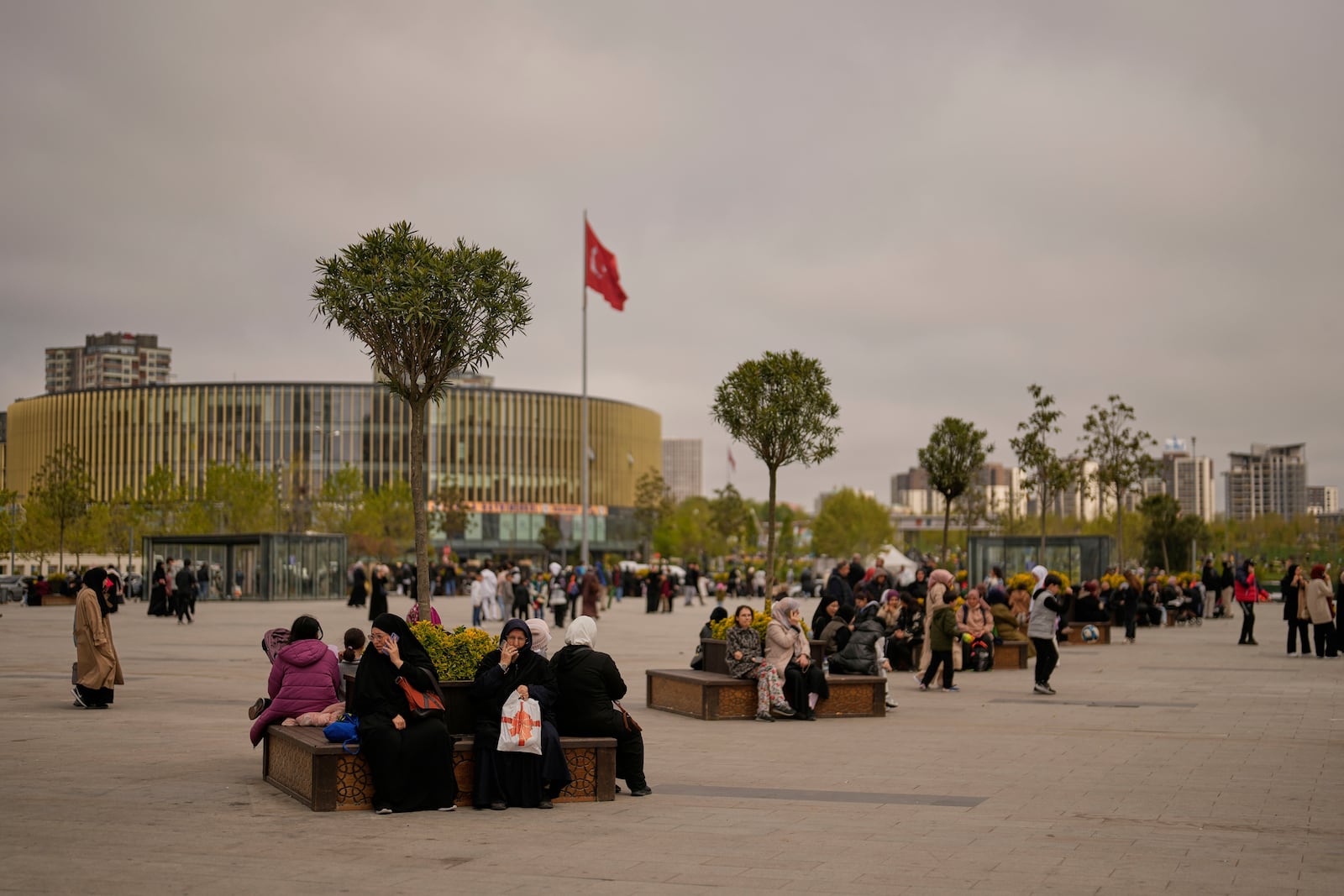 People gather outdoors following an earthquake shock with a preliminary magnitude of 6.2, in Istanbul, Turkey, Wednesday, April 23, 2025. (AP Photo/Khalil Hamra)