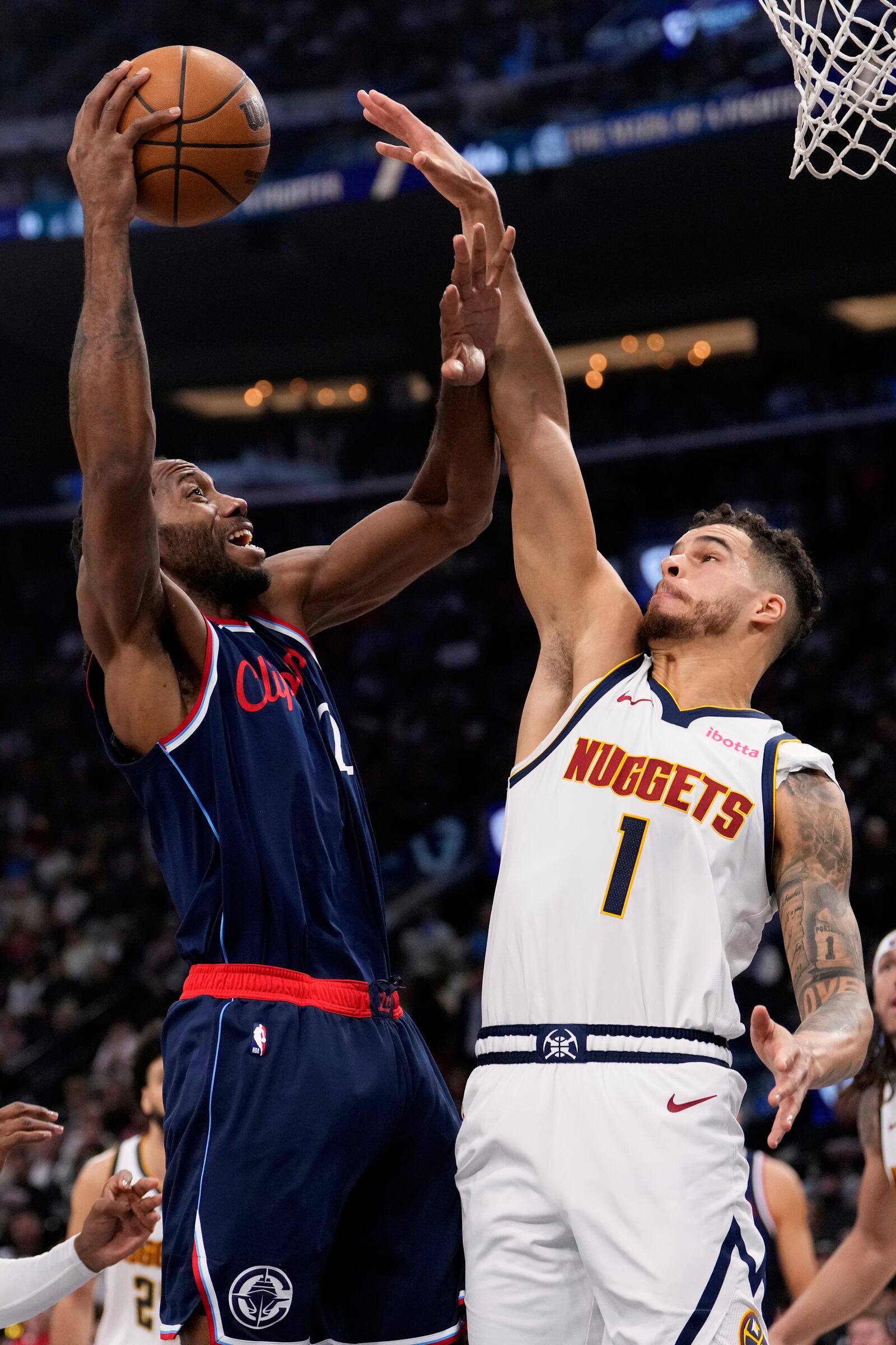 Los Angeles Clippers forward Kawhi Leonard, left, looks to shoot as Denver Nuggets forward Michael Porter Jr. (1) defends during the first half in Game 4 of an NBA basketball first-round playoff series Saturday, April 26, 2025, in Inglewood, Calif. (AP Photo/Mark J. Terrill)