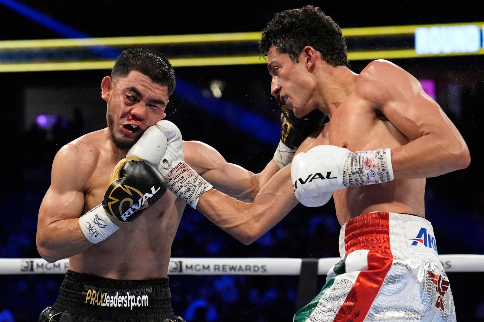 Rafael Espinoza hits Edward Vazquez in a featherweight title boxing match Sunday, May 4, 2025, in Las Vegas. (AP Photo/John Locher)