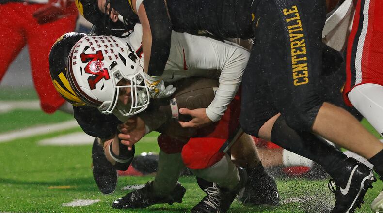 Wayne quarterback, Tyrell Lewis, is sacked by a pack of Centerville defenders during Friday's Regional championship game. BILL LACKEY/STAFF