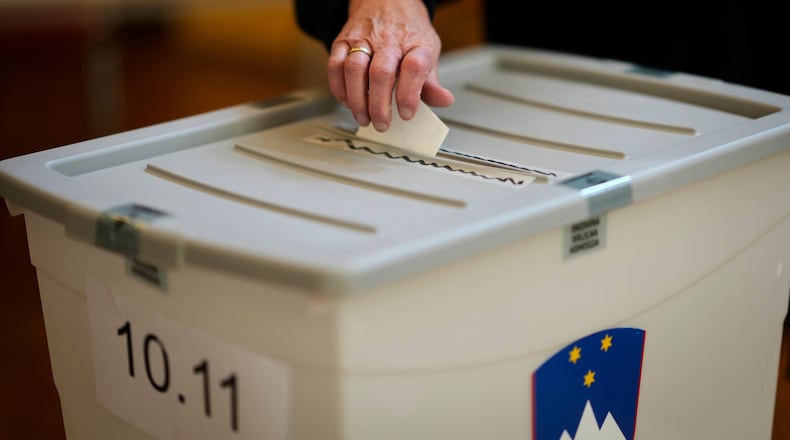 A voter casts her ballot at a polling station during the referendum on assisted dying for terminally ill patients, in Domzale, Slovenia, Sunday, Nov. 23, 2025. (AP Photo/Darko Bandic)