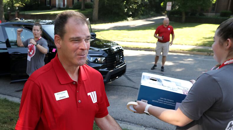 Wittenberg University President Mike Frandsen helps a student carry their things into the dorm Thursday, August 25, 2022 during Move-In day. BILL LACKEY/STAFF