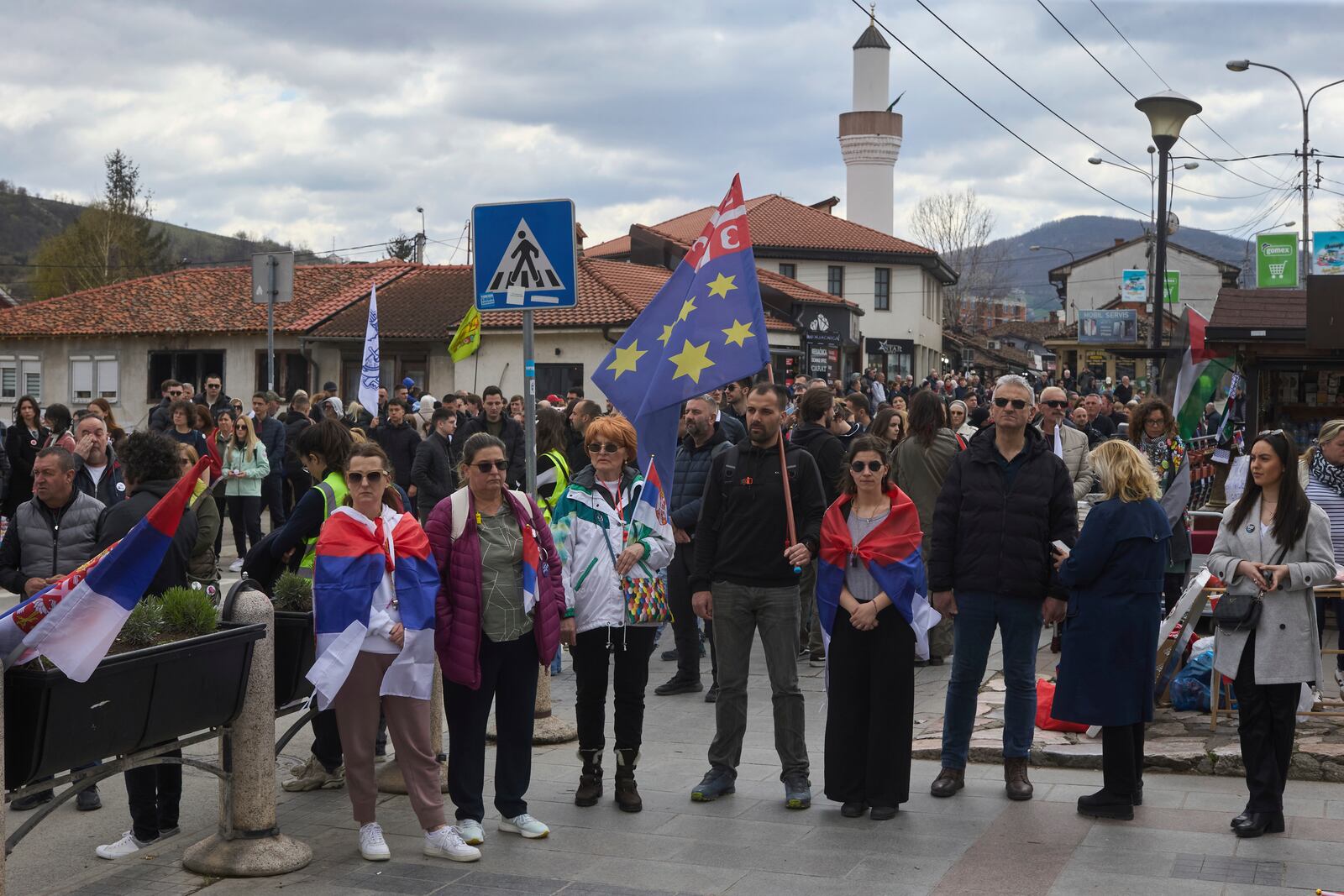 People observe seventeen minutes of silence while they attend an anti-corruption protest in the southwestern town of Novi Pazar, Serbia, Saturday, April 12, 2025. (AP Photo/Marko Drobnjakovic)
