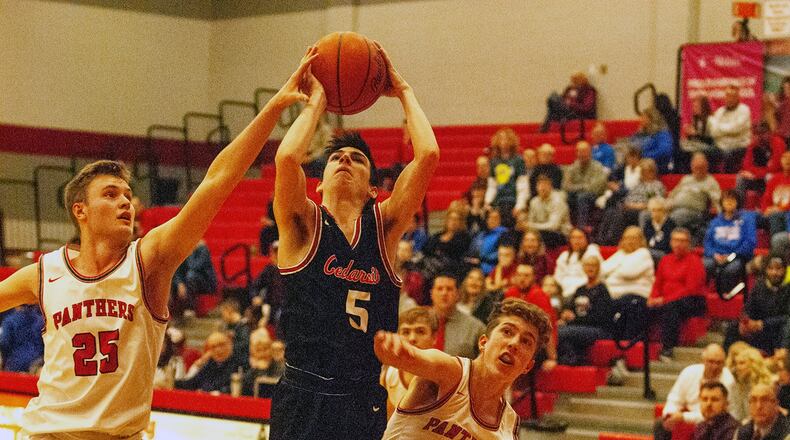 Cedarville’s Peyton Herron is fouled by Twin Valley South’s Cole Peterson during the second half Thursday night in Cedarville’s 53-40 victory over Twin Valley South at Troy High School in a Division IV sectional semifinal. Jeff Gilbert/CONTRIBUTED