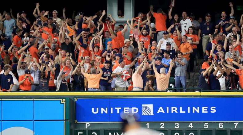 HOUSTON, TX - OCTOBER 21:  Fans cheer as Evan Gattis #11 of the Houston Astros rounds the bases after hitting a a solo home run against CC Sabathia #52 of the New York Yankees during the fourth inning in Game Seven of the American League Championship Series at Minute Maid Park on October 21, 2017 in Houston, Texas.  (Photo by Ronald Martinez/Getty Images)
