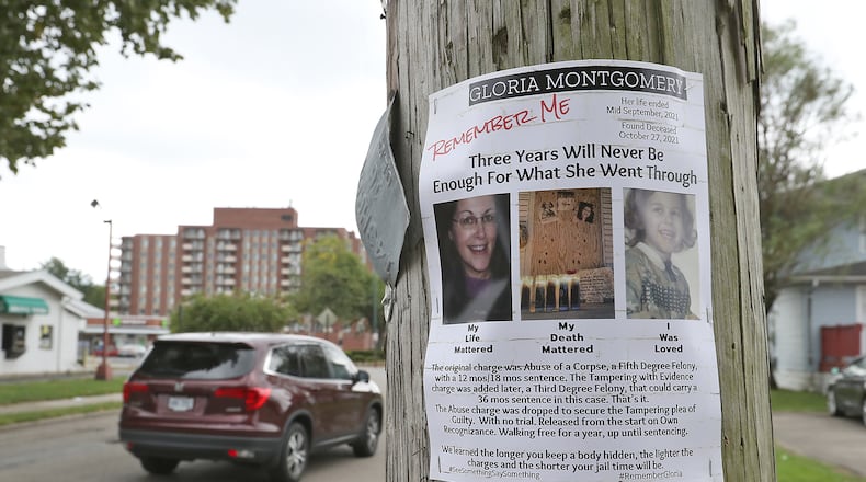 Flyers are stapled to utility poles in the North Douglas Avenue neighborhood where Gloria Montgomery's body was found in a duplex in October 2021. Eric Beedy, Montgomery's boyfriend, was sentenced to three years in prison for tampering with evidence in the case. BILL LACKEY/STAFF