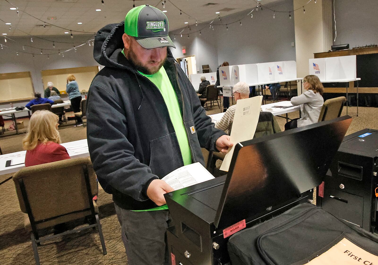 Casey Tingley puts his ballot in the voting machine Tuesday, March 19, 2024 at the First Christian Church on Middle Urbana Road. BILL LACKEY/STAFF