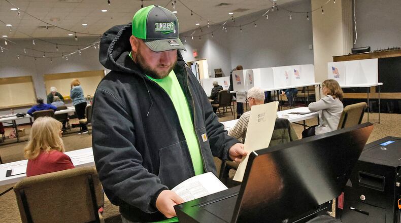 Casey Tingley puts his ballot in the voting machine Tuesday, March 19, 2024 at the First Christian Church on Middle Urbana Road. BILL LACKEY/STAFF