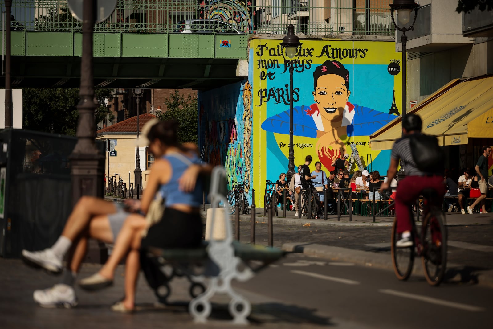 Artist Franck Duval, aka FKDL, works on a mural of U.S.-French entertainer and civil rights activist Josephine Baker in Paris, Saturday, July 19, 2025. (AP Photo/Thomas Padilla)