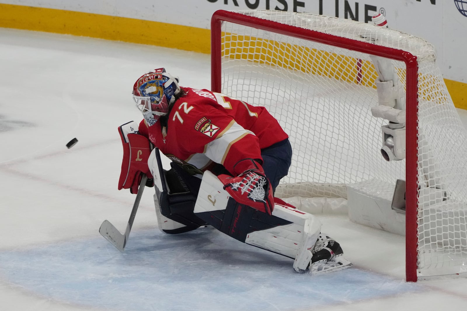 Florida Panthers goaltender Sergei Bobrovsky (72) deflects a shot on goal during the third period in Game 4 of the NHL hockey Stanley Cup Eastern Conference finals against the Carolina Hurricanes, Monday, May 26, 2025, in Sunrise, Fla. (AP Photo/Lynne Sladky)