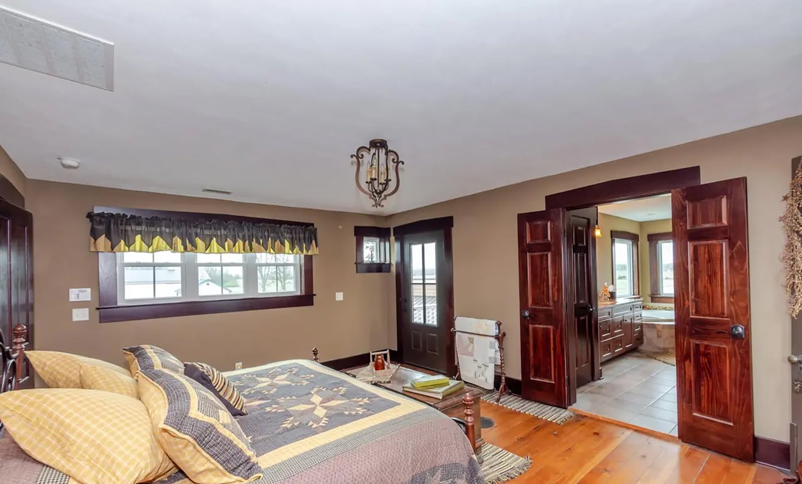 The second floor primary bedroom suite has hardwood flooring in the bedroom, a walk in closet and an ensuite bathroom with updated vanities, soaking tub and walk in shower. There is also an exterior door opening to a private balcony. CONTRIBUTED