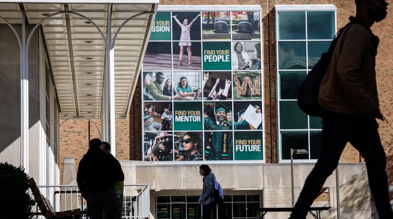 Wright State University students hustle to class Tuesday Oct. 26, 2021. Some colleges and universities have seen lower enrollment. JIM NOELKER/STAFF