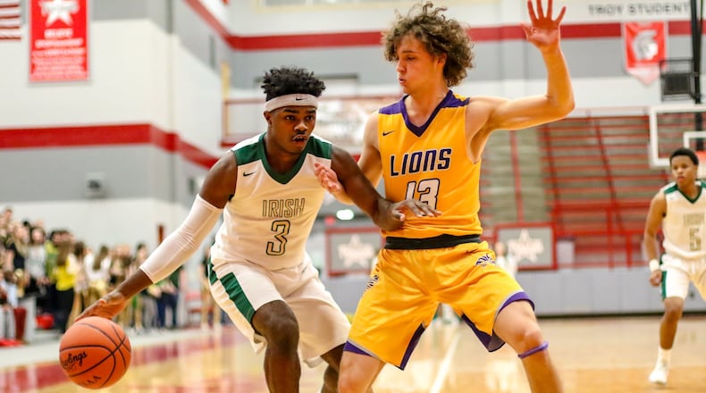 Catholic Central senior Jayden Borden drives past Emmanuel Christian Academy’s Casey Swank during their Division IV sectional final game on Saturday night at Troy High School. The Irish won 62-57. CONTRIBUTED PHOTO BY MICHAEL COOPER