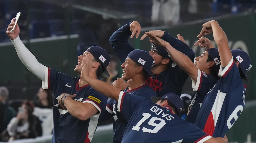South Korea players take a selfie as they celebrate after defeating Australia in their World Baseball Classic game on Monday, March 9, 2026 in Tokyo. (AP Photo/Eugene Hoshiko)