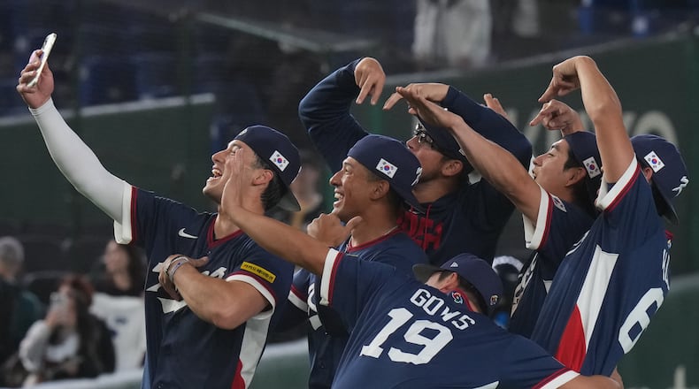 South Korea players take a selfie as they celebrate after defeating Australia in their World Baseball Classic game on Monday, March 9, 2026 in Tokyo. (AP Photo/Eugene Hoshiko)