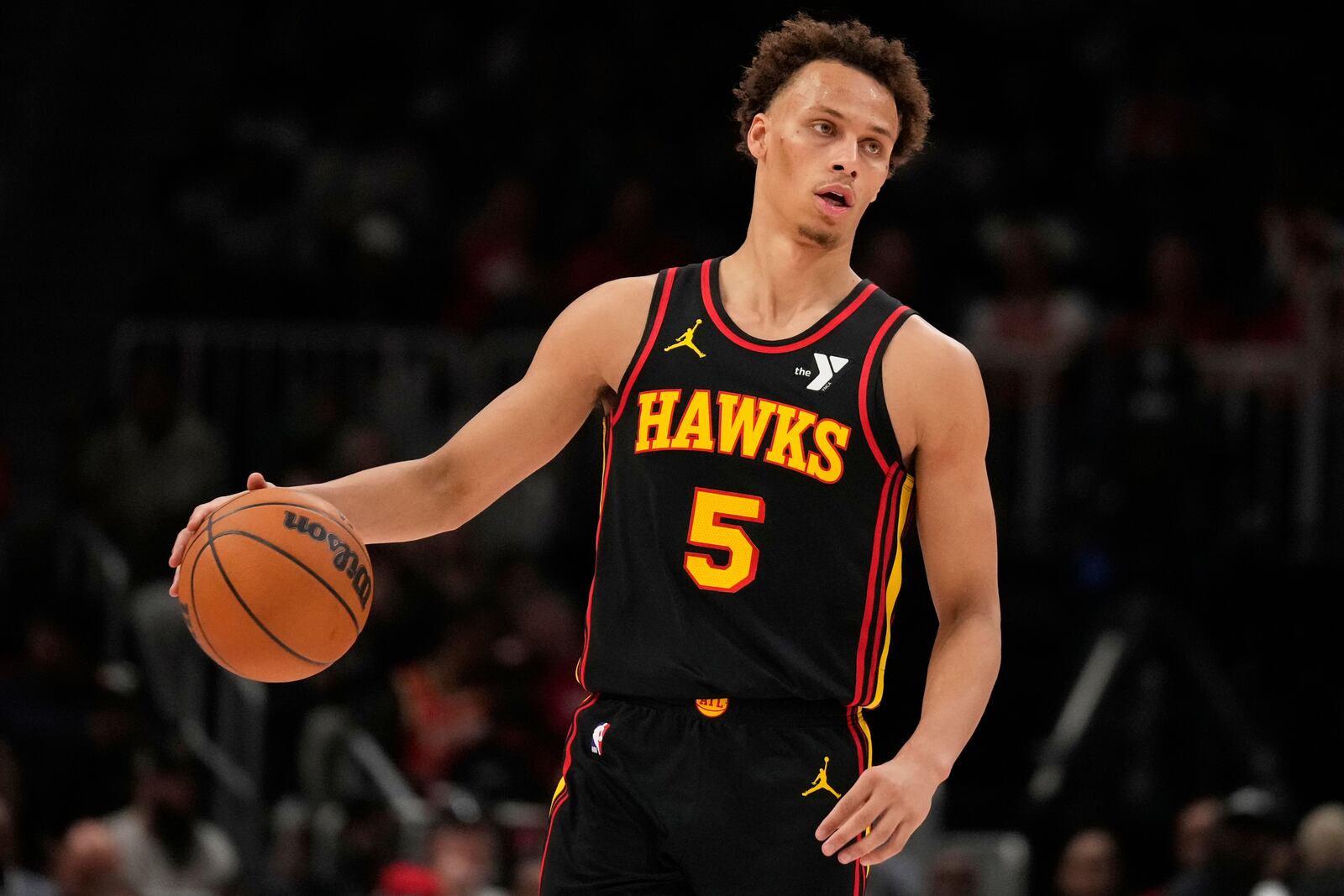 Atlanta Hawks guard Dyson Daniels (5) dribbles in the first half of an NBA play-in tournament basketball game against the Miami Heat, Friday, April 18, 2025, in Atlanta. (AP Photo/Brynn Anderson)