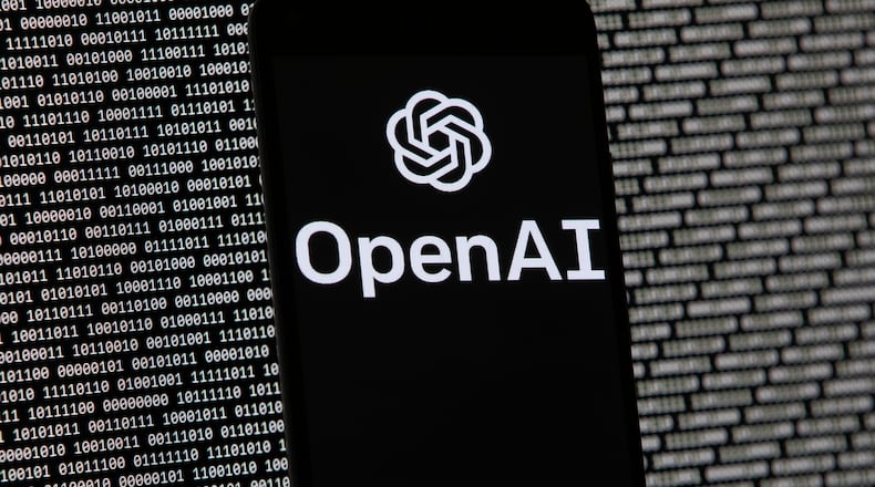 FILE - The OpenAI logo appears on a mobile phone in front of a computer screen with random binary data, March 9, 2023, in Boston. (AP Photo/Michael Dwyer, File)