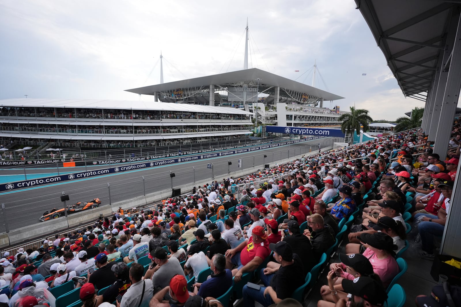 Fans watch McLaren driver Oscar Piastri of Australia race past during the Formula One Miami Grand Prix auto race Sunday, May 4, 2025, in Miami Gardens. Fla. (AP Photo/Rebecca Blackwell)
