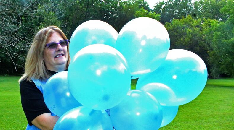 Carmela Wiant gets ready to release balloons to honor her son who was killed in an auto accident. Wiant helped get a state law passed to create a Next of Kin Registry. JEFF GUERINI/STAFF