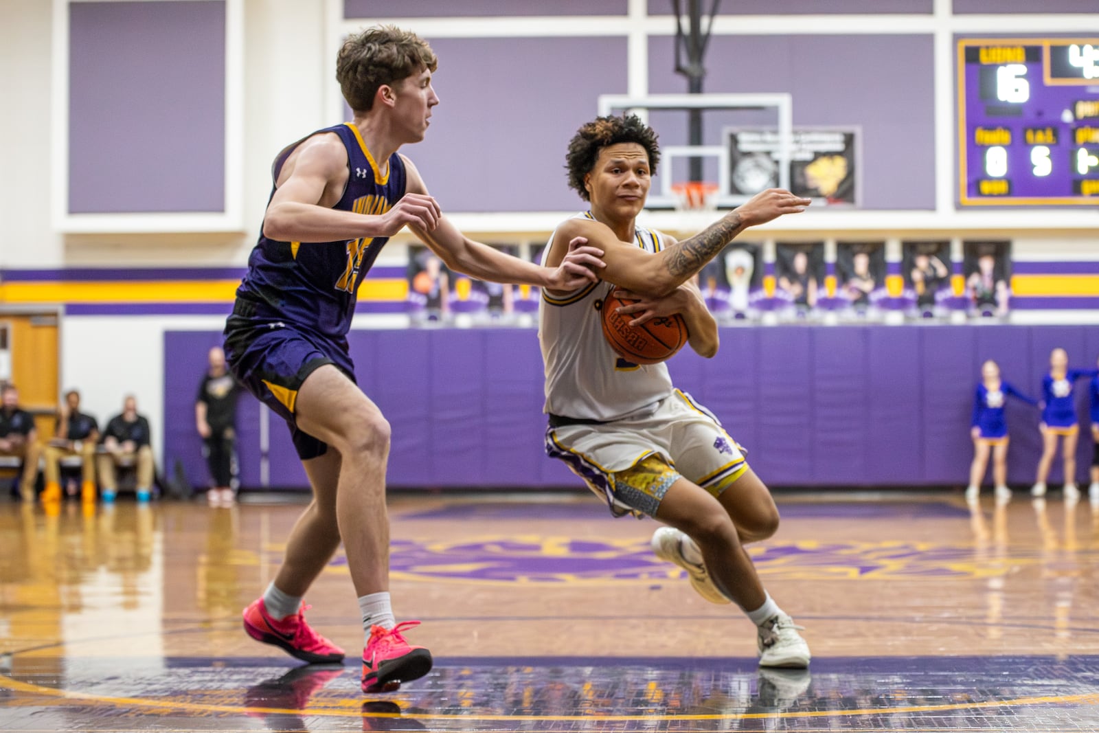 Emmanuel Christian junior Jayden Thomas drives past Mechanicsburg senior Lucas Bowman during their game on Tuesday, Feb. 17 in Springfield. The Lions won 70-60. MICHAEL COOPER / STAFF