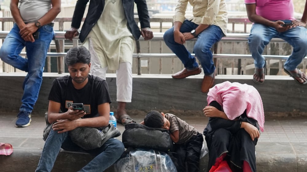 Passengers wait at the Hazrat Shahjalal International Airport after several flights were cancelled or delayed due to the US-Israeli attack on Iran, in Dhaka, Bangladesh, Sunday, March 1, 2026. (AP Photo/Al-emrun Garjon)
