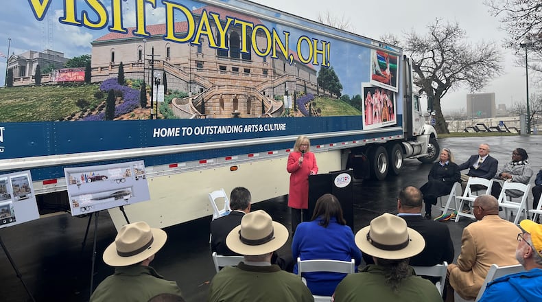 Jacquelyn Powell, president and CEO of the Dayton Convention & Visitors Bureau, speaks at an event where the third semi-trailer with images promoting Dayton was unveiled. The truck is likely to travel about 100,000 miles all over the country each year. CORNELIUS FROLIK / STAFF
