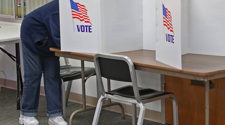 A woman casts her vote at the Springfield poll in the Covenant United Methodist Church Tuesday. BILL LACKEY/STAFF