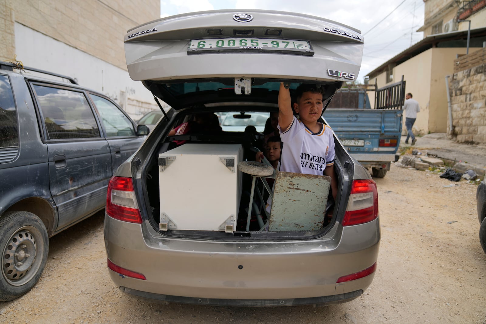 Residents of the now evacuated refugee camp of Tulkarem return to collect belongings before the destruction of their homes as Israeli forces prepare to carry out the demolition of 116 homes across the two refugee camps of the Israeli occupied West Bank city of Tulkarem, Friday, May 2, 2025. (AP Photo/Nasser Nasser)