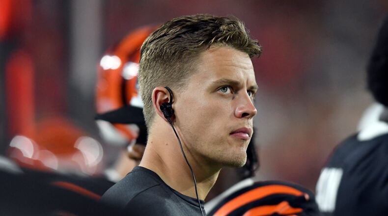 Cincinnati Bengals quarterback Joe Burrow (9) watches from the sidelines during the first half of an NFL preseason football game against the Tampa Bay Buccaneers Saturday, Aug. 14, 2021, in Tampa, Fla. (AP Photo/Jason Behnken)