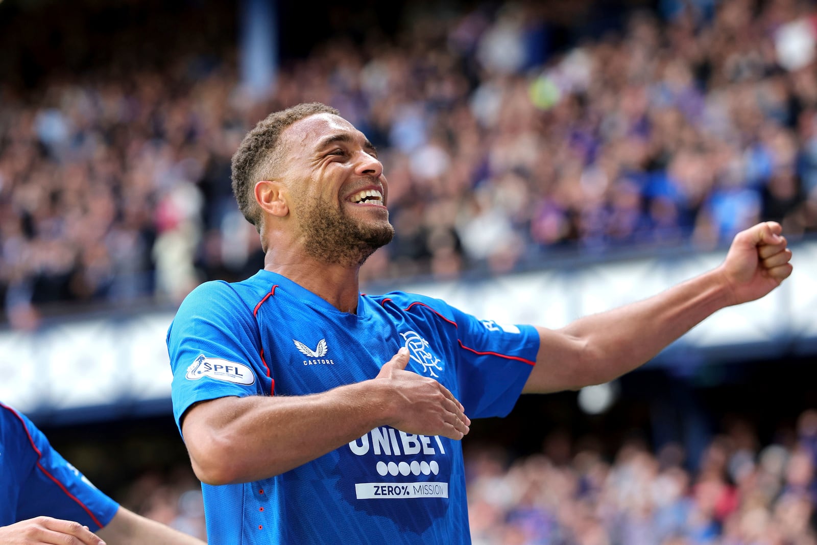 Rangers' Cyriel Dessers celebrates scoring their side's first goal of the game during the Scottish Premiership soccer match between Rangers and Celtic at Ibrox Stadium, Glasgow, Scotland, Sunday, May 4, 2025. (Steve Welsh/PA via AP)