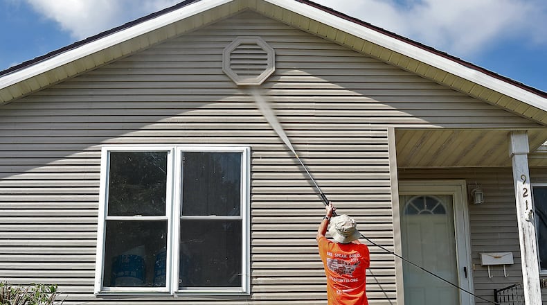 Participants in The Fuller Center Bike Adventure stopped in Springfield in July to help with several projects including renovating a house on Gothic Street and clearing a lot for a playground. BILL LACKEY/STAFF