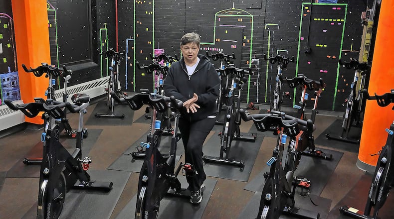 Pat Frock, owner of Springfield Health and Fitness, talks about the new spinning room she’s added recently. Springfield Health and Fitness has increased its membership by double. Bill Lackey/Staff