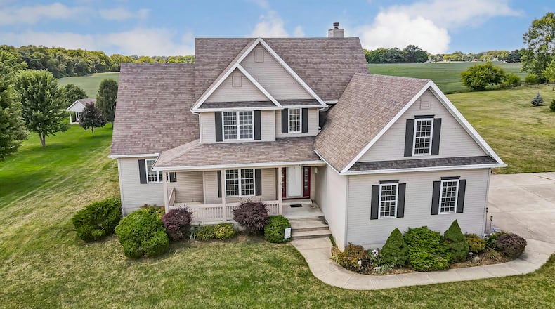 The vinyl sided two story has a covered front porch and a three car attached side entry garage with openers.