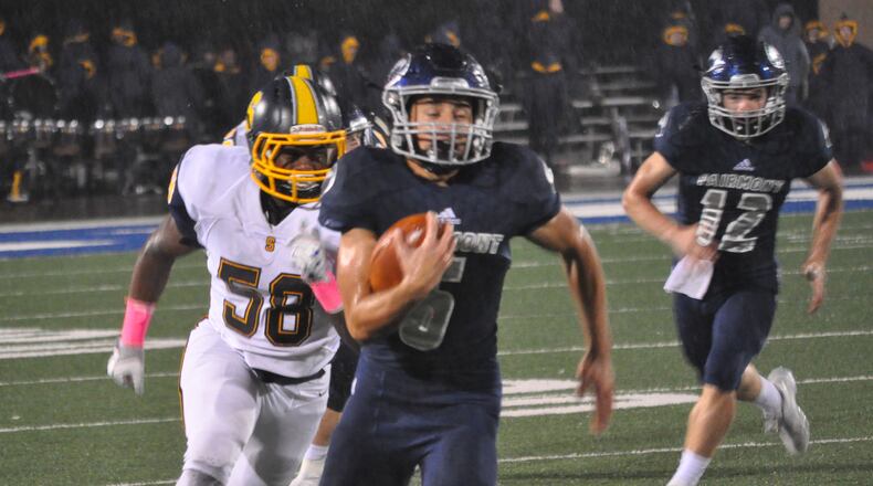 Fairmont running back Kennon Burroughs tries to outrun Springfield defensive end Te’Vion Gilbreath during a Week 10 contest at Roush Stadium Oct. 27, 2017. Nick Dudukovich/CONTRIBUTED