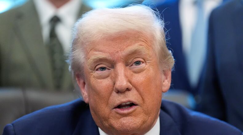 President Donald Trump speaks to reporters after signing a spending bill that ends a partial shutdown of the federal government in the Oval Office of the White House, Tuesday, Feb. 3, 2026, in Washington. (AP Photo/Alex Brandon)